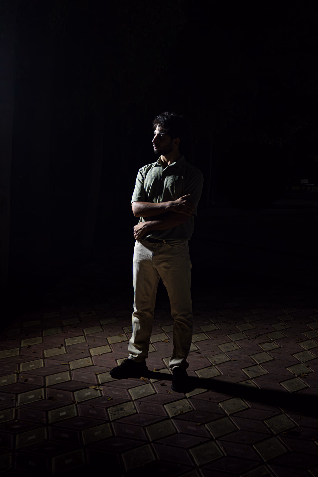 Person standing in front of a light in a dark environment
